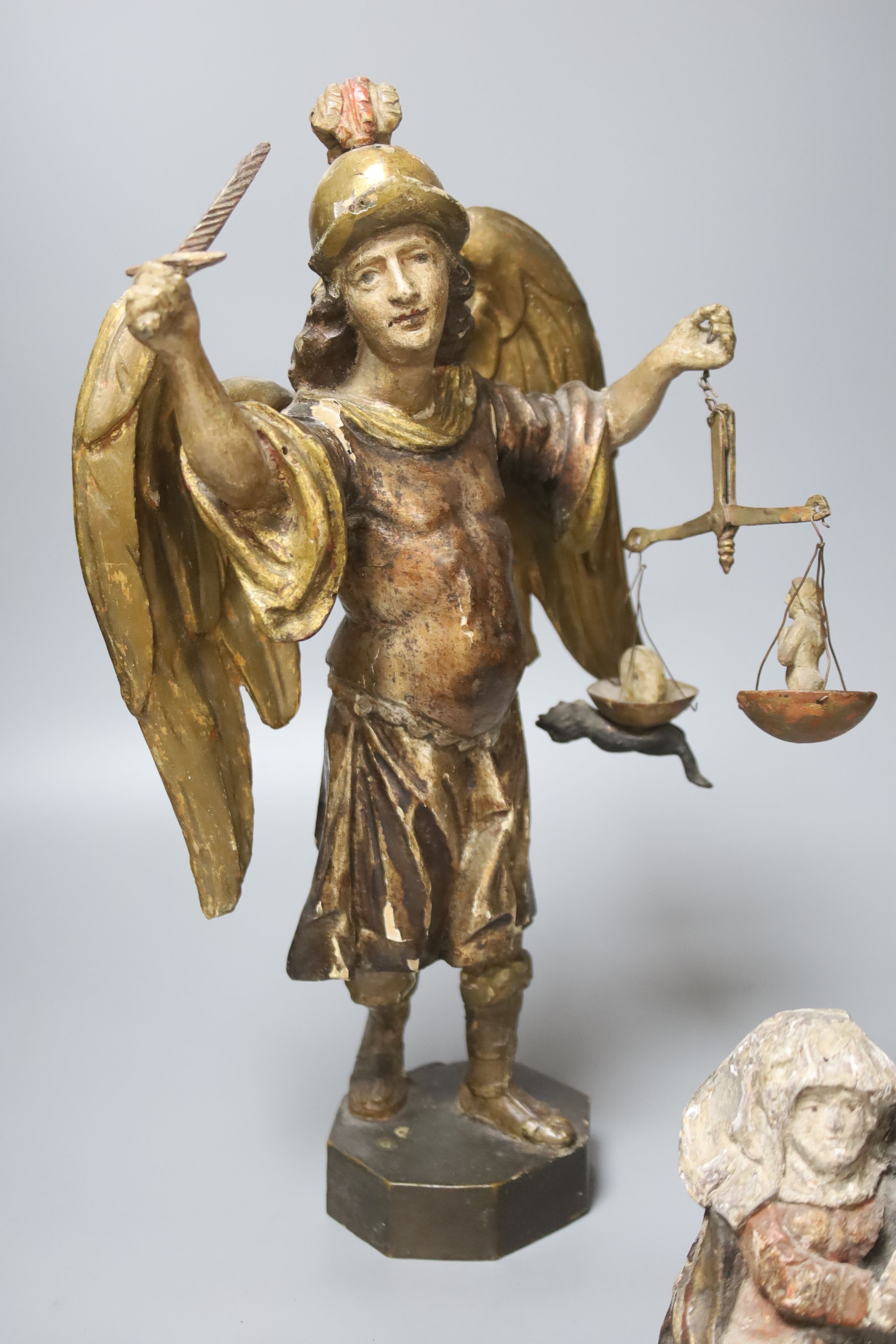 An 18th / 19th century Italian carved polychrome wood figure of Gabriel, height 37cm, and three other carvings